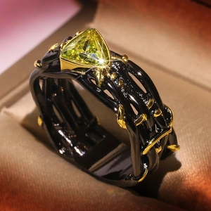 Vintage black and gold ring with triangular yellow gemstone and gothic镂空 textures