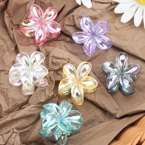 Plumeria flower hair clips in various pearlescent colors for beach vacation styles