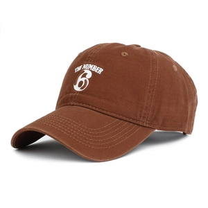 Brown cotton baseball cap with white The Number 6 embroidery in a classic 6-panel style