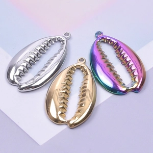 Three stainless steel cowrie shell pendants in gold, silver, and iridescent finishes