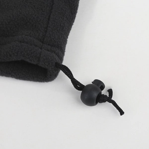 Detail of adjustable drawstring with plastic spring toggle on black fleece neck warmer