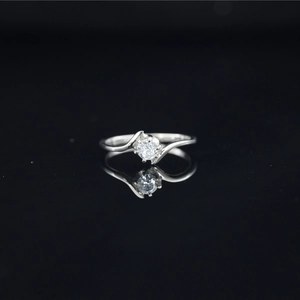 Titanium steel ring with round moissanite in a twisted silver band on black background