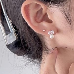 925 sterling silver stud earrings with square zircon and pearl on ear close-up