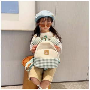 Detail showing beige and green checkered kids backpack with cute 3D cartoon ears