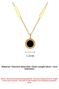 Detail of gold titanium steel necklace with Roman numeral disc and black onyx inlay