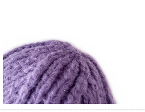 Close-up detail of soft purple knitted fabric showing fine yarn texture on children's hat