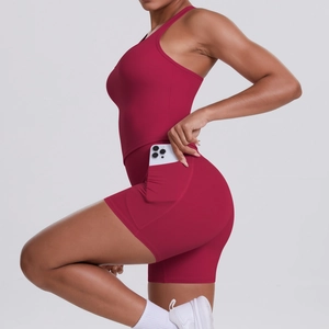 Detail view of burgundy racerback sports top and shorts with side pocket feature