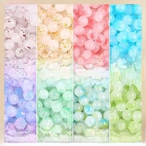 Detailed view of 8mm jelly glass beads with gold dust and gradient textures for DIY jewelry