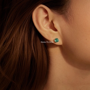 S925 sterling silver stud earrings with 6mm green rose-cut diamond-like stones on model