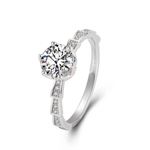 Macro shot of silver six-prong crown ring with brilliant-cut stone and stepped micro-pave band