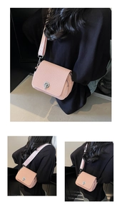 Detailed view of pink woven mini crossbody bag with wide shoulder strap and silver lock