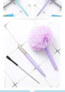 Detailed view of dismantled purple fluffy pompom ballpoint pen showing refill components