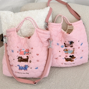 Detailed embroidery of cats and dogs on soft quilted pink tote bag with shoulder straps