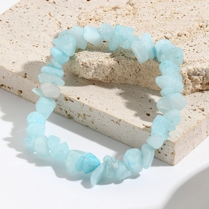 Macro shot of natural turquoise stone fragments on a minimalist elastic bead bracelet