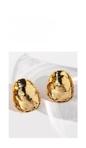Macro shot of 18K gold organic hammered texture earrings with liquid metal aesthetic
