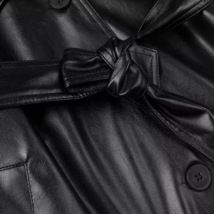 Long black faux leather trench coat for women featuring a stylish waist belt and buttons