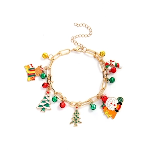 Detailed shot of Christmas charm bracelet with gold chain, reindeer, and Santa pendants