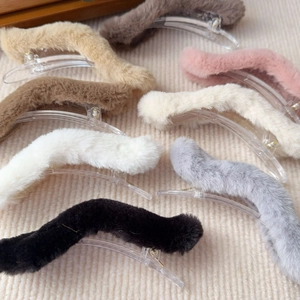 Flat lay of colorful plush faux fur duckbill hair clips in seven autumn winter shades