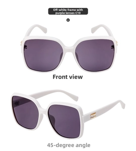 Macro detail of square cream frames with purple lenses and golden wing accents