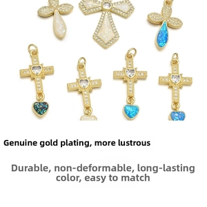 Detail of cross and flower pendants in gold-plated copper with zircon and opal
