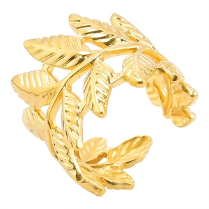 Macro detail of golden laurel leaf ring showing metallic texture and layered leaf design