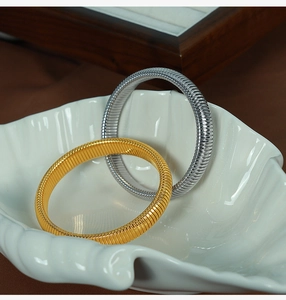 Detail of 10mm retro textured stretch bracelets in gold and silver finish