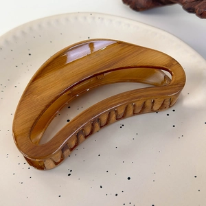 French vintage crescent hair claw clip in tortoiseshell acrylic on a ceramic dish
