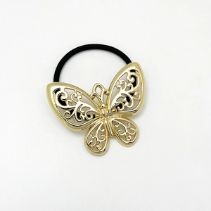 Detail of high-elastic black hair tie with hollow golden alloy bow-knot design
