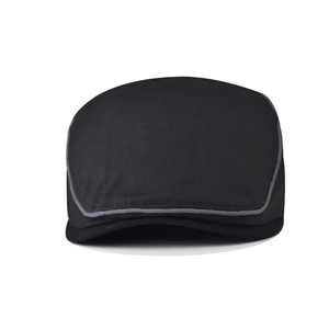 Front view of a black cotton flat cap with grey piping detail on a white background