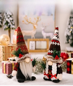 Detail of Christmas gnomes with knitted hats holding candy cane and ski poles