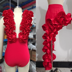 Detail of red V-neck swimsuit featuring dramatic ruffles and sleek satin-finish bodysuit