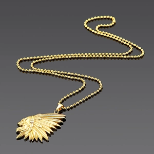 Detailed close-up of golden Indian chief pendant on a ball chain necklace