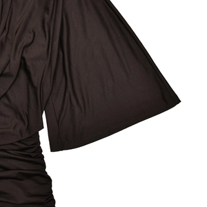 Detailed view of dark brown flared sleeves with elegant pleated ruffles and soft texture