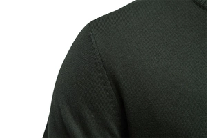 Detail shot of the fine knitting technique and shoulder seams on this dark green cardigan
