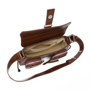 Detail view of brown faux leather bag showing interior lining and multiple zip pockets