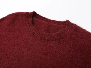 Détail d'un pull col rond bordeaux montrant la texture douce de la maille mohair