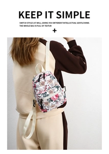 Detail of floral canvas backpack featuring pink yellow leaf patterns and zip closure