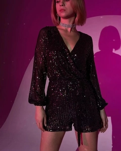 Detailed close-up of V-neck sequined black long sleeve romper for evening parties