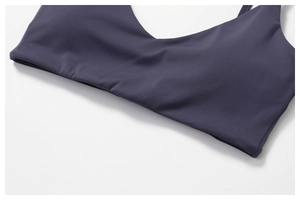 Detail of navy blue high-elastic knit sports bra with refined U-neck stitching