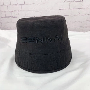 Close-up of black bucket hat with embroidered SENWAI lettering on the front