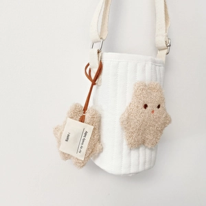 Quilted white fabric bottle bag with plush star and adjustable strap for kids