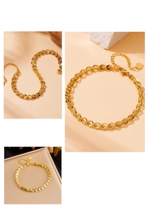 Detail of gold-plated stainless steel wheat chain bracelet with a small heart charm
