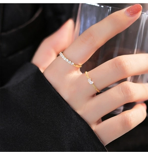 Close-up of double-layered gold rings with zircon heart and half-circle diamond accents
