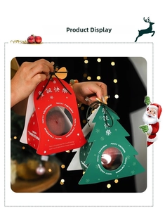 Close-up of Christmas gift boxes with transparent windows and ribbons for apples