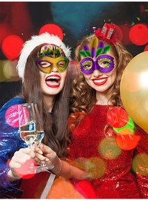 Detail of two colorful carnival masks featuring vibrant feathers and gold lace trim