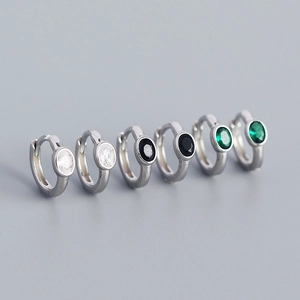 Detail view of S925 silver hoop earrings with white, black, and green round zircon stones