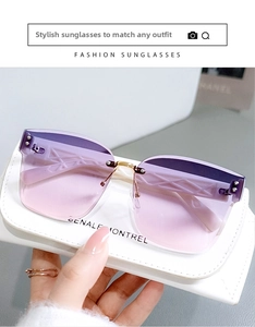Detail of rimless sunglasses with purple gradient lenses and silver rivet accents