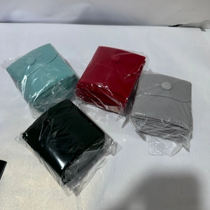 Macro shot of assorted velvet jewelry pouches with snap buttons in four colors