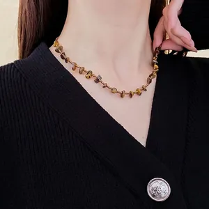 Maillard brown tiger eye stone beaded necklace with golden accents on a model