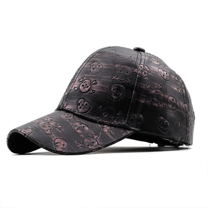 Close-up of vintage PU leather baseball cap featuring embossed skull pattern texture